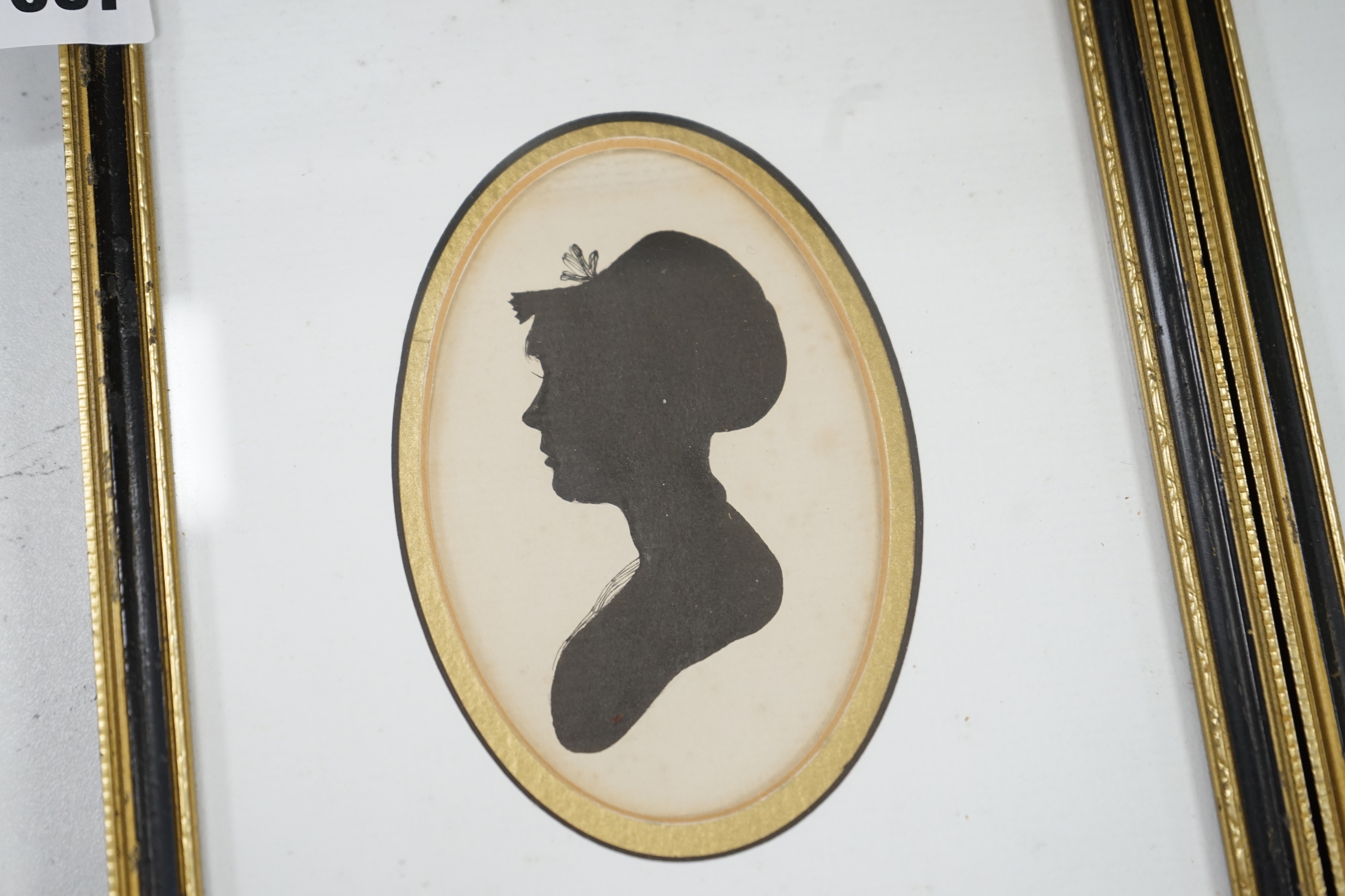 A pair of Georgian oval painted silhouette portraits, lady and gentleman, 10 x 6.5cm